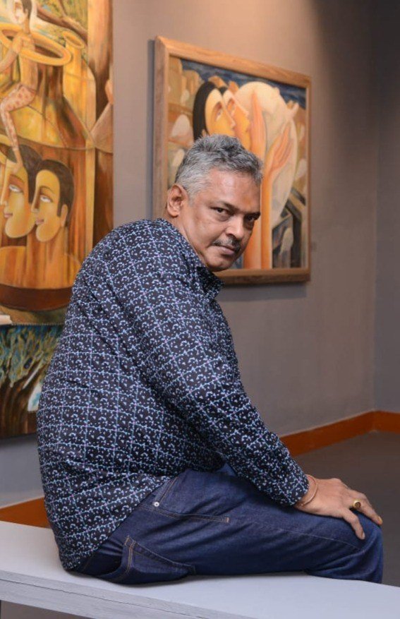 Tapan Dash portrait in front of paintings